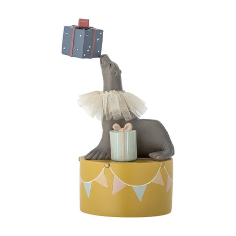 Multicoloured polyresin sea lion resin candle holder, 19cm, balancing a wrapped parcel on its nose atop a bunting-design drum, with a second gift beside it on white background.