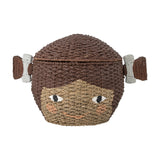 Lill Basket with Lid in Brown, a woven Bankuan grass kids' storage basket shaped like a smiling face with two side bunches, lid as hair, on a white background.