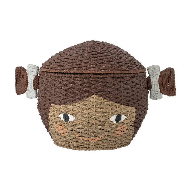 Lill Basket with Lid in Brown, a woven Bankuan grass kids' storage basket shaped like a smiling face with two side bunches, lid as hair, on a white background.