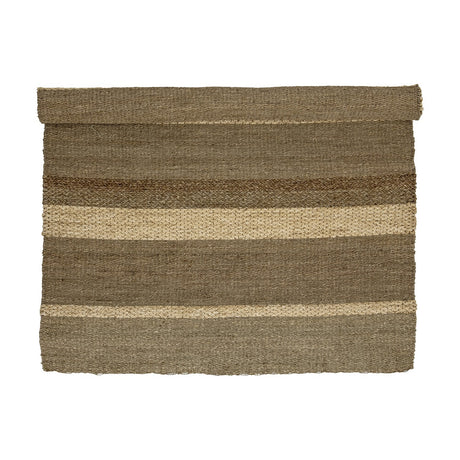 Felex Striped Seagrass Rug, 260x180cm, partially rolled, showing broad natural-toned stripes with alternating flat and braided woven textures on a plain white background.