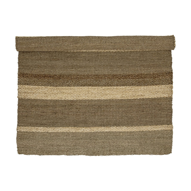 Felex Striped Seagrass Rug, 260x180cm, partially rolled, showing broad natural-toned stripes with alternating flat and braided woven textures on a plain white background.