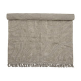 Elaine Wavy Cotton Rug 210x150cm in natural, partially rolled to show a tufted wavy pattern on flat-woven cotton with fringed edge, on a plain background.