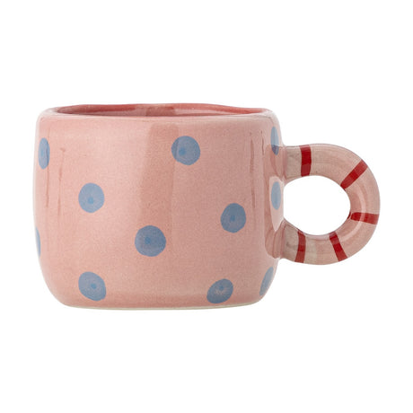 Nini Dotted Stoneware Cup in pink with hand-painted blue dots and a red-striped ring handle, 100ml kids' cup shown on a plain white background.