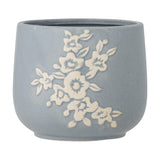 Betino Floral Stoneware Plant Pot in blue, round with a slightly tapered base, featuring a raised white floral spray design and speckled finish, shown on a plain white background.