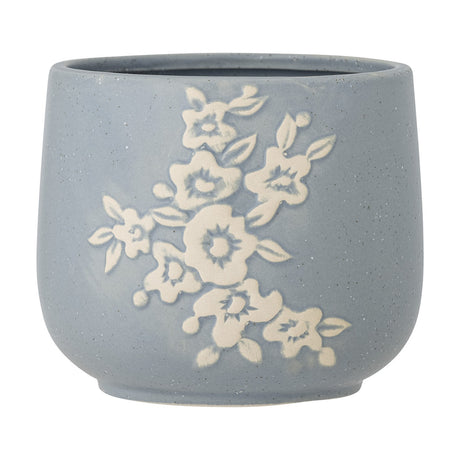 Betino Floral Stoneware Plant Pot in blue, round with a slightly tapered base, featuring a raised white floral spray design and speckled finish, shown on a plain white background.
