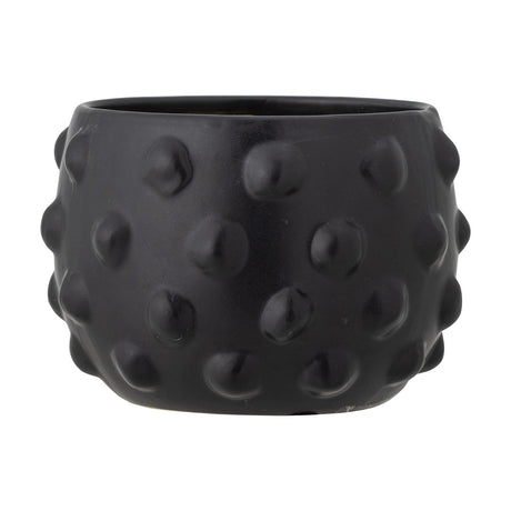Parvin Terracotta Plant Pot in black, round wide-bodied design with raised dot texture covering the surface, shown on a plain white background.