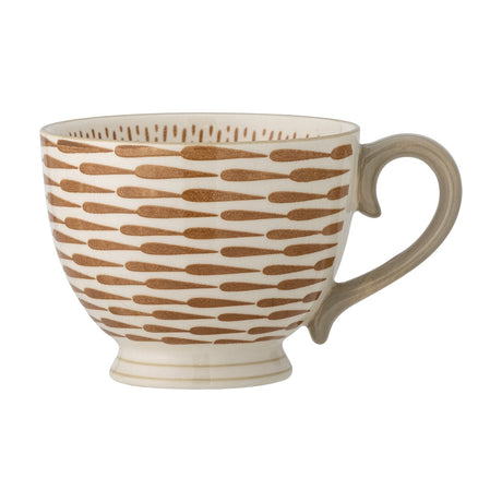 Maple Stoneware Mug 420ml in orange, footed ceramic cup with curled loop handle and rows of orange teardrop patterning on a cream body, shown on a plain white background.