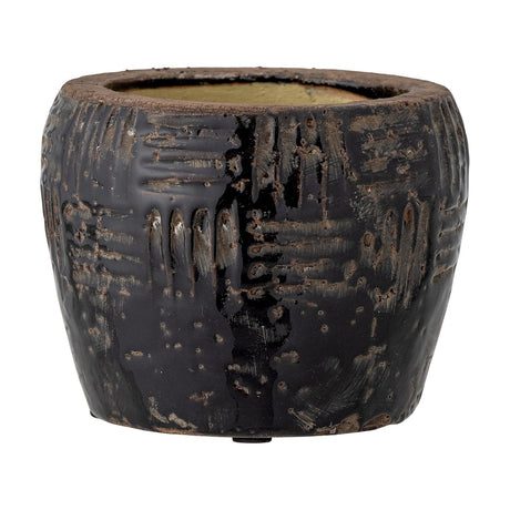 Muan Embossed Terracotta Plant Pot in black, round tapered shape with basket-weave textured pattern and worn glossy finish, shown on a plain white background.