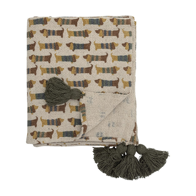 Charlie Cotton Throw in multicoloured cotton blend, folded with a dachshund dog print and olive green tassel corners, shown against a plain white background.