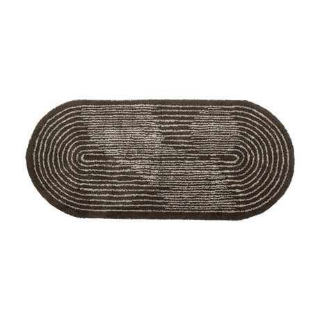 Zhina Oval Cotton Rug, 160x70cm, in brown tufted cotton with a shaggy pile and concentric oval line pattern, shown on a plain white background.