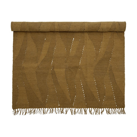 Zola Wool Rug 200x140cm in brown, partially rolled, showing a woven tonal pattern of angled bands with fine open gaps and fringed edges on a plain white background.