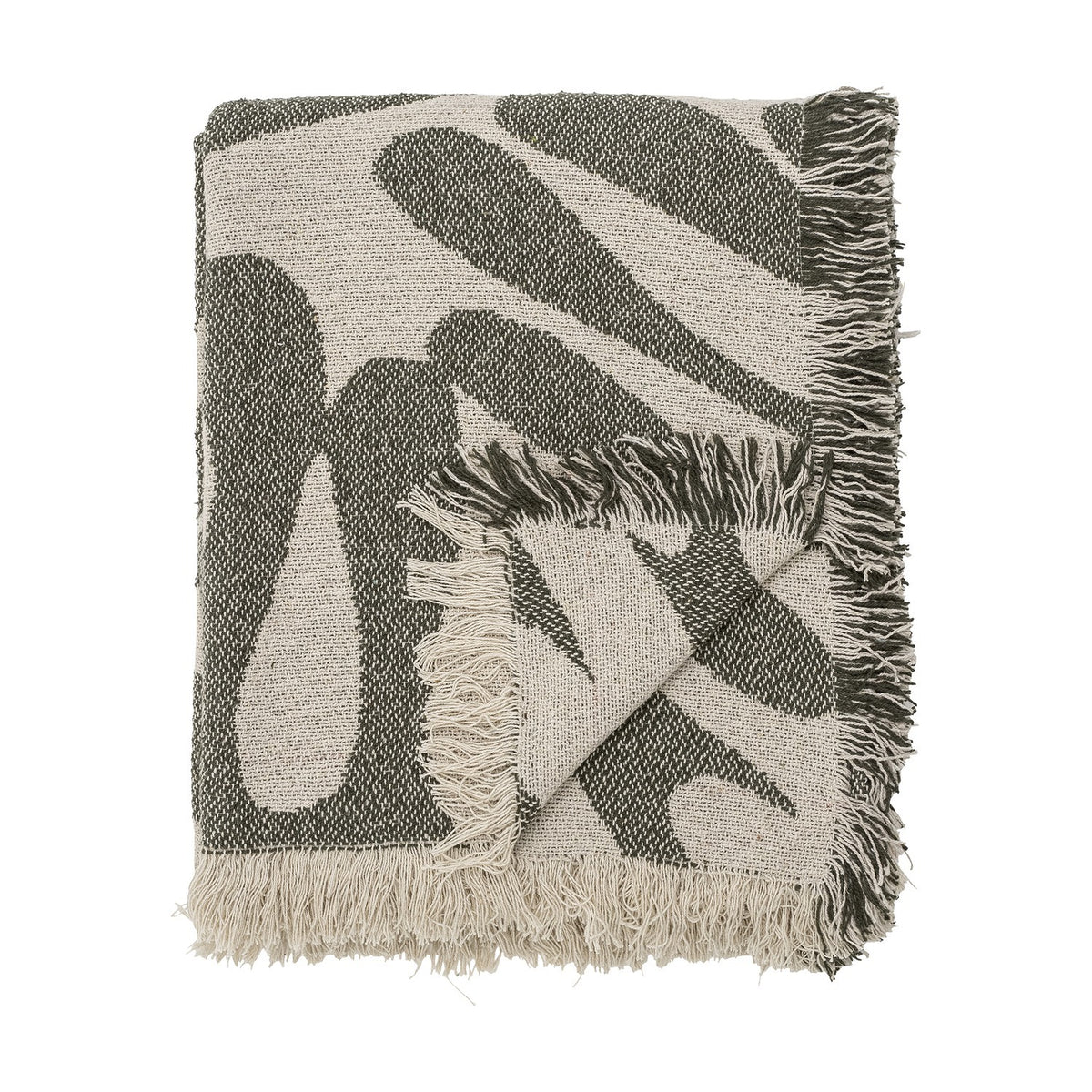 Alk Cotton Throw in green, folded showing a woven abstract leaf pattern in olive and cream with fringed edges, on a plain white background.