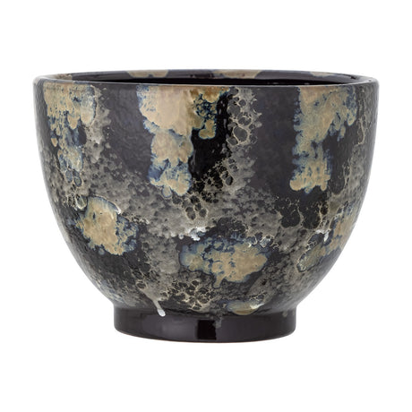 Sayed stoneware plant pot in black, a rounded bowl on a short foot with a glossy, mottled glaze in lichen-like speckled patches, shown on a plain white background.