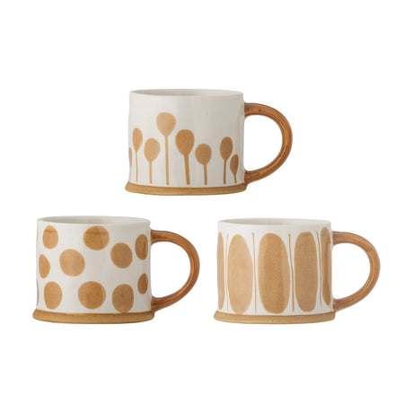 Linora Stoneware Mugs 450ml, set of 3 in white ceramic with tan handles, each hand-painted with a different motif: spoon shapes, dots, and tall ovals, on a plain white background.