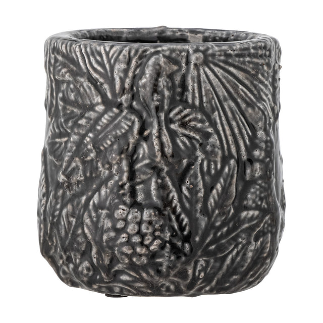 Nikou Terracotta Plant Pot in black, round shape with raised botanical leaf and fruit relief covering the glossy surface, shown on a plain white background.