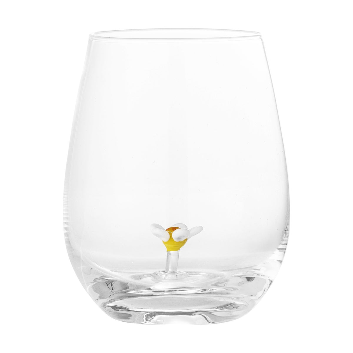 Misa Floral Tumbler in clear mouthblown glass with a rounded, stemless body and a small white and yellow glass flower rising from the base, shown on a plain white background.