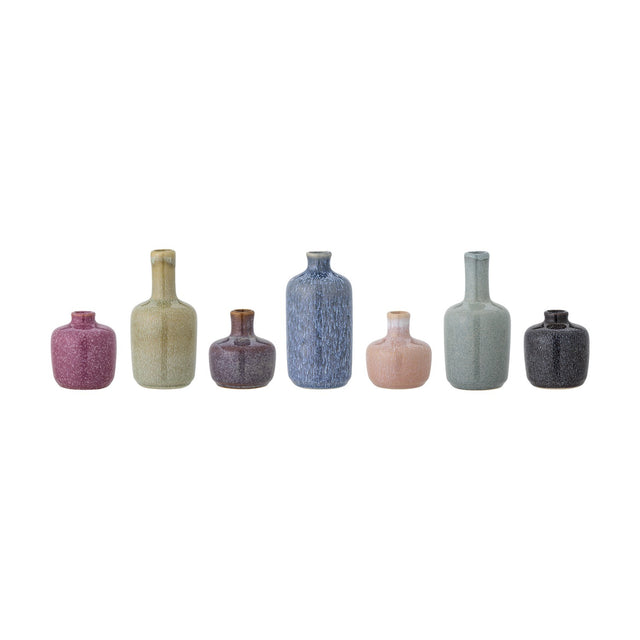 Maien Speckled Stoneware Vases, set of 7, in varying bottle and rounded shapes with narrow necks, finished in speckled glazes of plum, sage, blue, pink, grey and black, on a plain white background.