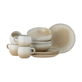 Paula Stoneware Breakfast Set of 12 in beige, with reactive-glazed cups, bowls and plates in rounded rustic ceramic shapes on a plain white background.