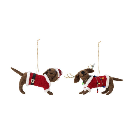Set of two Monty Wool felted sausage dog Christmas ornaments in red Santa suits with fluffy trim, one wearing a Santa hat, the other with antlers and mini fairy lights.