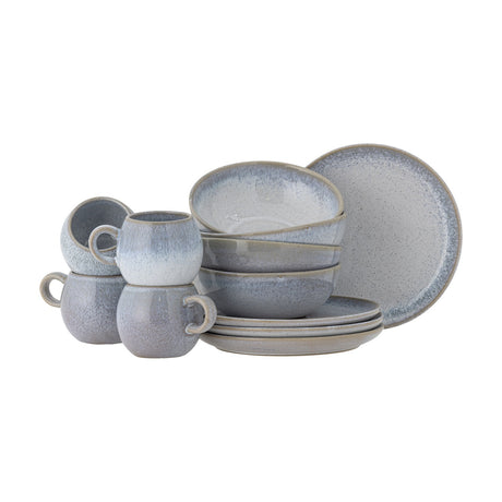 Paula Speckled Stoneware Breakfast Set of 12 in blue, with reactive-glaze cups, bowls and side plates in rounded rustic shapes, shown on a plain white background.