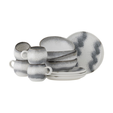 Paula Wavy Stoneware Breakfast Set of 12 in grey, with rounded handled cups, wavy-rimmed bowls, and plates in matching cloud-like grey glaze, shown on a plain white background.