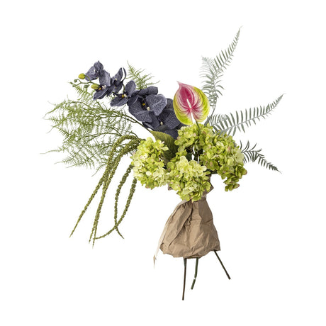 Poetry Artificial Bouquet in Green featuring large green hydrangea heads, dark veined orchid sprays, a pink anthurium, ferns and trailing foliage, wrapped in paper, on a white background.