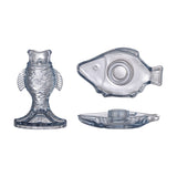 Linley Fish Glass Candle Holders in blue, shown upright and flat, with scale and fin detailing and open-mouth candle sockets, on a white background.