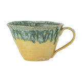 Milani Green Stoneware Cup 250ml with a flared bowl and loop handle, featuring a reactive glaze in green dripping over a yellow base, shown on a plain white background.