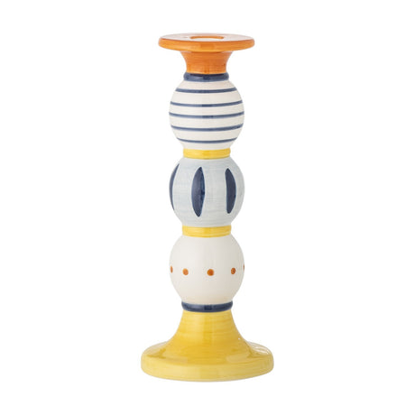 Kairi Stoneware Candle Holder 23cm, a multicoloured column of three patterned rounded sections—stripes, ovals, and dots—on a flared yellow base, shown on a white background.