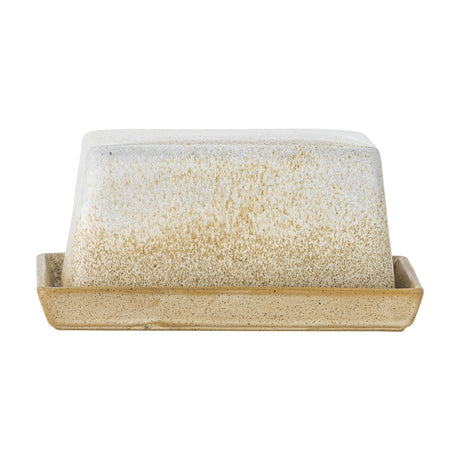 Paula Speckled Stoneware Butter Dish in cream, rectangular tray with tapered domed cover, speckled reactive glaze deepening towards the base, shown on a plain white background.
