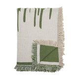 Haxby Throw in green, a fringed fabric blanket with bold hand-painted-style stripes on one corner folded to reveal the plain green reverse, shown against a white background.