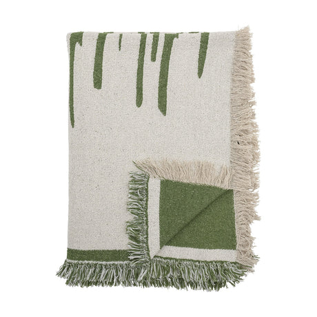 Haxby Throw in green, a fringed fabric blanket with bold hand-painted-style stripes on one corner folded to reveal the plain green reverse, shown against a white background.
