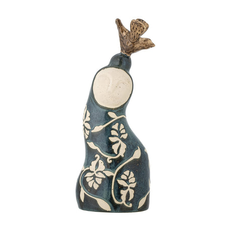 Layhan Stoneware Ornament in blue, a curved ceramic figure with a matt speckled face, floral vine patterns, and a bronze-toned bird perched on top, shown against a plain white background.
