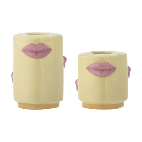 Sassy Stoneware Candle Holders Set of 2 in yellow, two glossy cylindrical holders of different heights with sculpted pink lips and side details, on a plain white background.