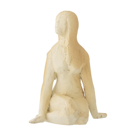Ishtar Stoneware Ornament in cream, a seated female figurine with folded legs, flat resting hands and long hair, shown rear-angled on a plain white background.