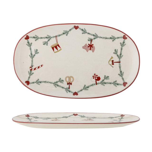Oval cream stoneware Christmas platter with red rim, featuring a pine garland, hearts, and ornament motifs like a drum, pig, candy cane, and pretzel, shown top and side views.