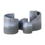 Meliad Stoneware Bookends Set of 2 in blue, curled ceramic forms with a glossy light blue band fading into speckled deep blue, shown on a plain white background.