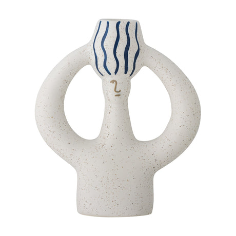 White stoneware candle holder shaped like a figure with looped arms, speckled finish, a simple painted face, and a taper cup with blue wavy stripes, shown on a plain background.