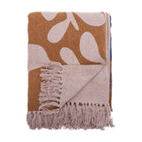 Atle Leaf Cotton Throw in brown, folded cotton throw with a large pale leaf print and knotted fringe edge, shown against a plain white background.