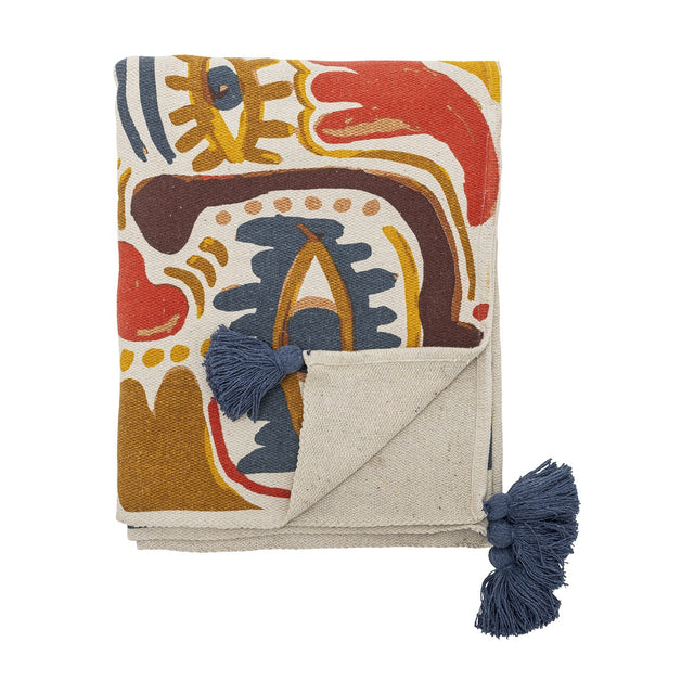 Horus Cotton Throw in Multi, folded cotton blend throw with bold abstract brushstroke pattern in red, blue, mustard and brown, finished with navy tassels, shown on a white background.
