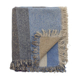 Maji Cotton Throw in Multi, folded cotton-blend throw with blue, charcoal and tan colour-block panels, tweedy flecked texture and loose fringed edges, shown on a plain white background.