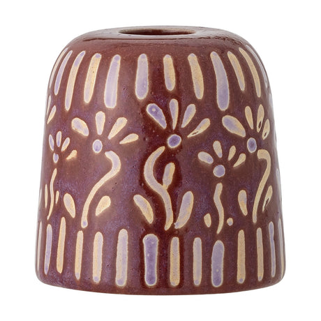 Samsin stoneware candle holder in red, a small domed shape with a single taper candle opening, decorated with pale stylised flowers and dash patterns, shown on a plain white background.