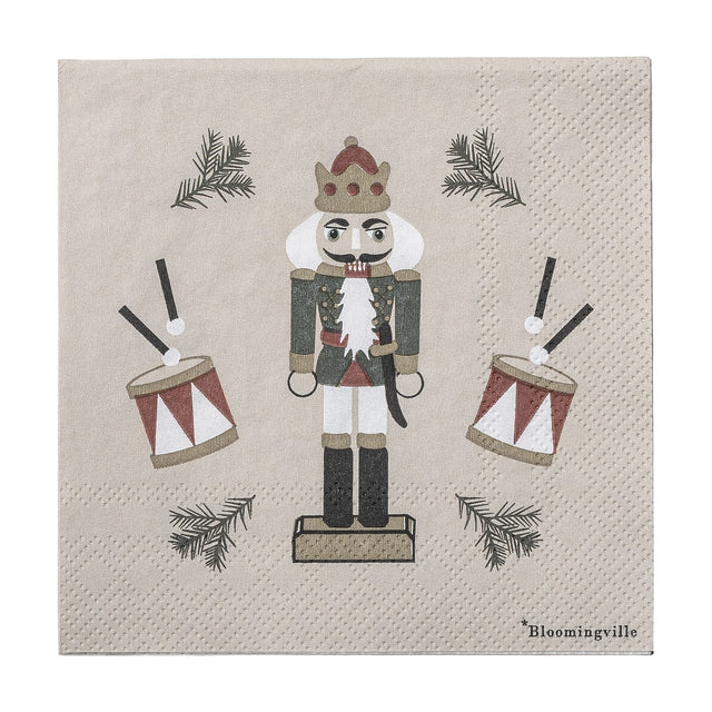 Jolly Paper Christmas Napkin in beige, pack of 20, featuring a crowned nutcracker soldier with drums and pine sprigs on a plain background.