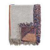 Clarita Cotton Throw in multicoloured woven cotton, folded to show cream, orange and blue geometric blocks with contrasting fringed edges on a white background.
