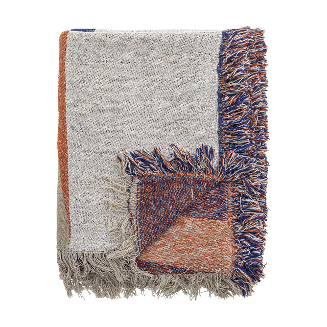 Clarita Cotton Throw in multicoloured woven cotton, folded to show cream, orange and blue geometric blocks with contrasting fringed edges on a white background.