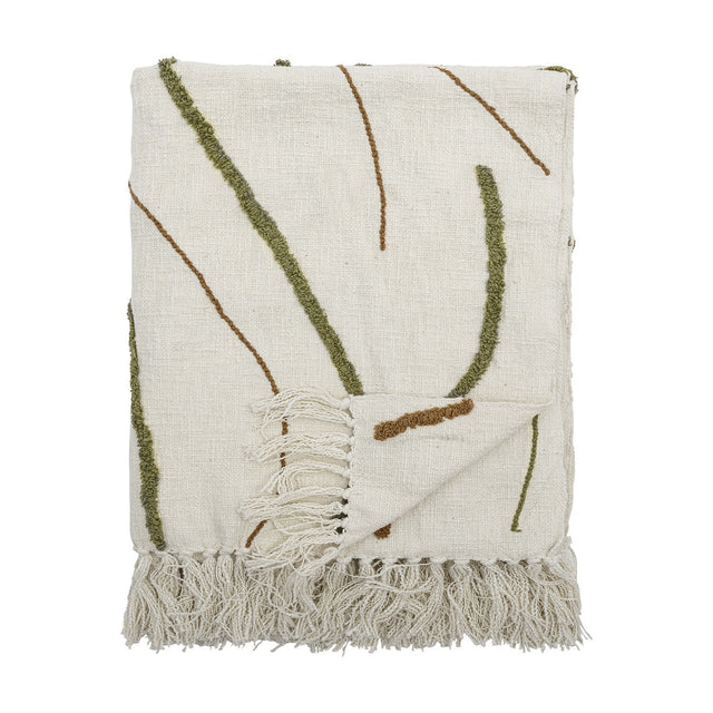 Osasio Cotton Throw in cream, folded, showing tufted olive green and fine brown stitched line patterns with knotted fringe edge, on a plain white background.