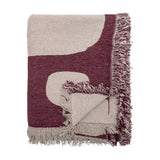 Folded Olica Cotton Throw in red with light beige curved shapes and fringed edges, shown against a plain white background.
