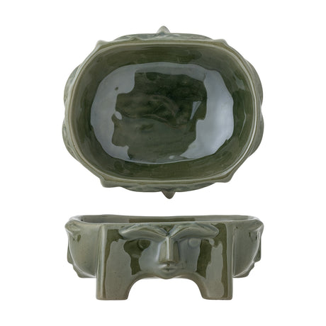 Amilia Stoneware Bowl 21x17.5cm in green, shown from top and side, oval shape with a moulded face in relief and short feet, glossy ceramic finish on a white background.