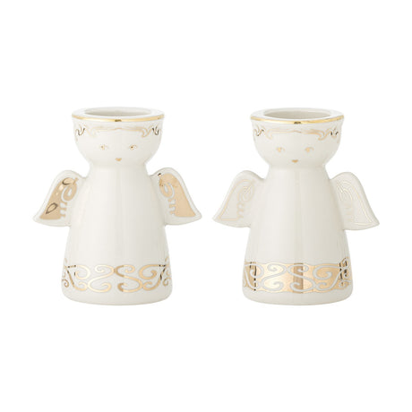 Set of two Faella angel-shaped ceramic tealight and candle holders in white with gold scrolled hem detail and wings, shown on a plain white background.