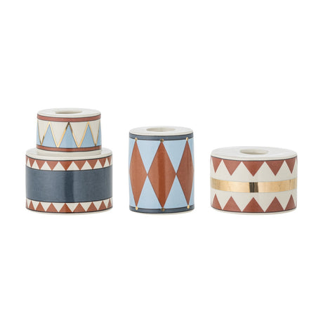 Bitja Geometric Christmas Candle Holders, set of three stoneware pieces in varied cylindrical shapes with multicoloured zigzag, triangle and diamond patterns, on a white background.